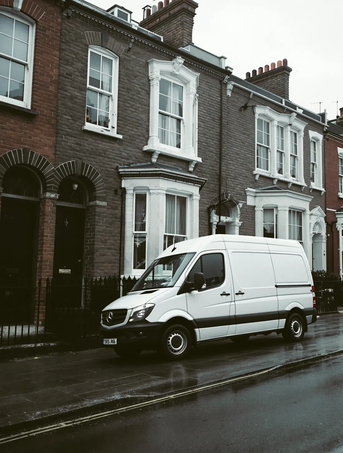 Work van outside a Victorian London brick terrace